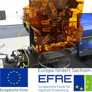 Plakat: Europäischer Fond für regionale Entwicklung. Bild eines technischen Gerätes.