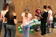 Foto: Schülerinnen stehen um einen Rennwagen des WHZ Racing Teams in der Aula Scheffelberg.
