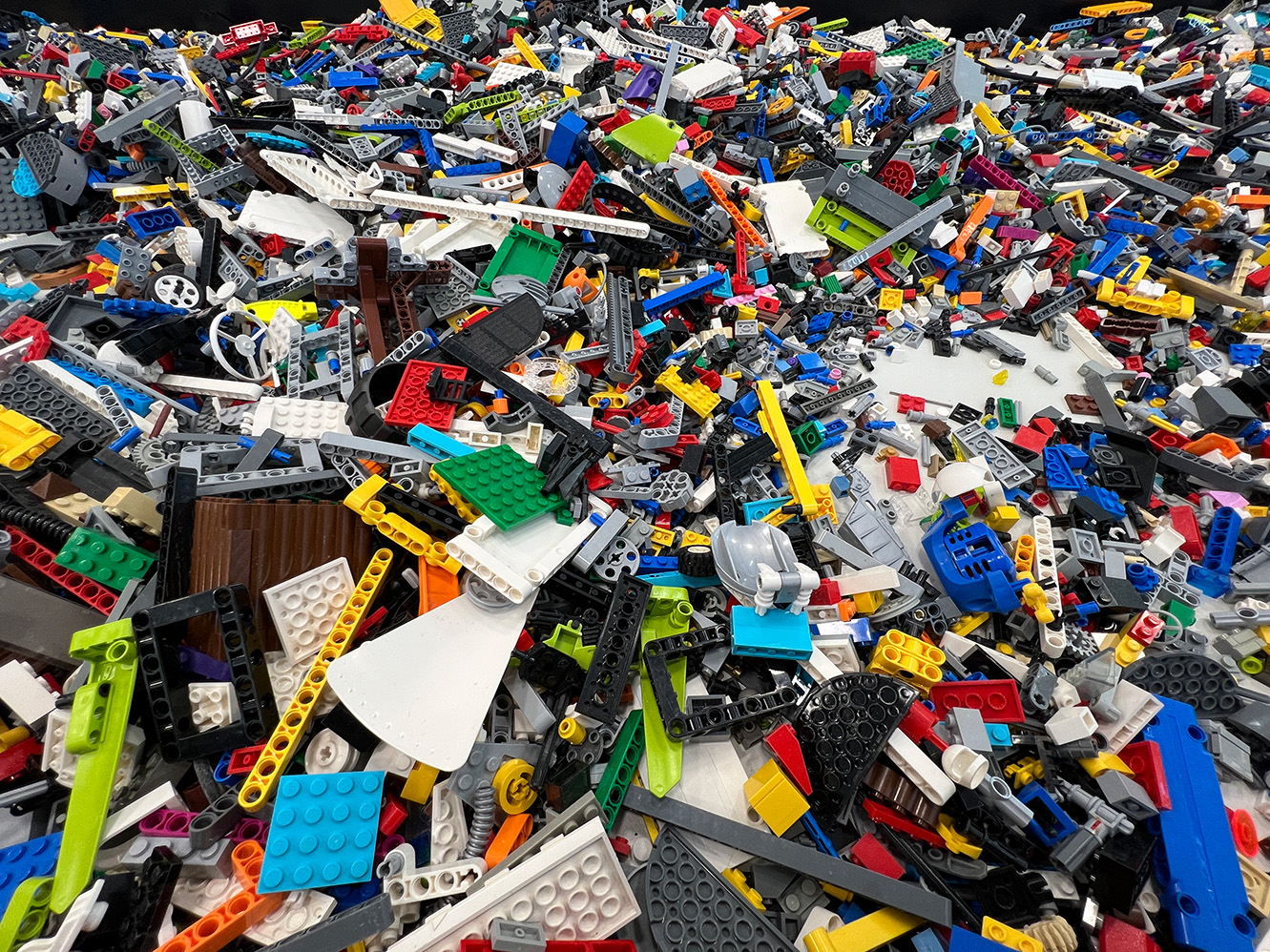 Viele unterschiedliche Legobausteine liegen auf einem Tisch